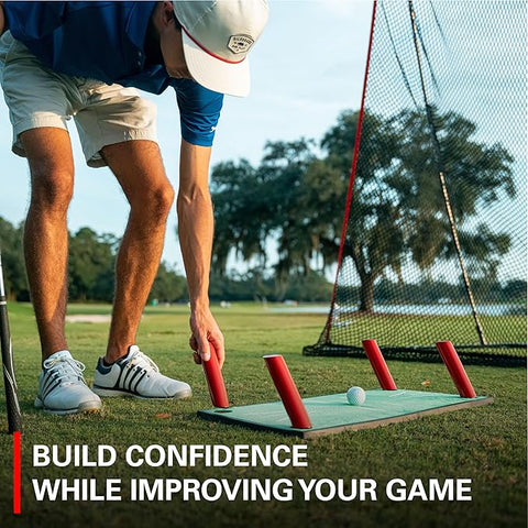 A golfer uses the Rukket Pathfinder Impact Swing Trainer with red barriers to practice on a putting mat near a net. The image displays "Build confidence while improving your game" at the bottom. Brand: Rukket.