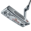A close-up of the Scotty Cameron 2025 Studio Style Newport 2 Plus Putter highlights precision milling, red Studio Style script, Newport 2 Plus engraving, a textured face, and visible screws on the head.