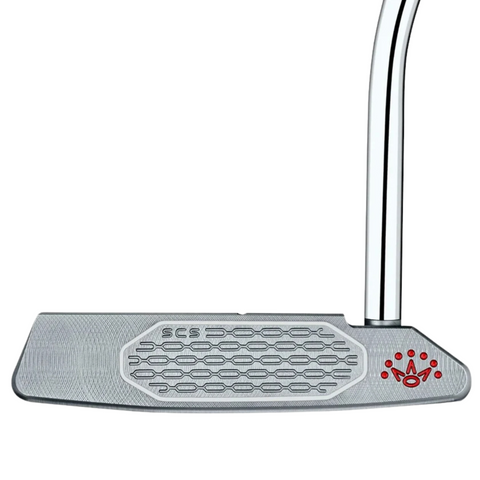 A close-up of the Scotty Cameron 2025 Studio Style Squareback Putter head, showing its honeycomb-patterned face, engraved SCS, and red paw print-and-crown logo—precision milled for performance.