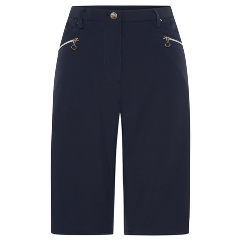 The Sporte Leisure Womens Core Short by Sporte Leisure are navy blue, knee-length golf shorts featuring a front button and zipper closure plus two angled zippered pockets with silver hardware for lightweight performance.