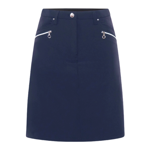 The Sporte Leisure Women’s Core Skort is a navy blue A-line golf skort with two front white diagonal zippered pockets and a button waistband closure.