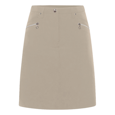 The Sporte Leisure Women’s Core Skort in beige features two silver zippered front pockets and a button closure at the waistband, displayed against a white background.