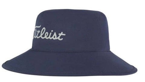 The Titleist 2023 Stadry Bucket Hat is a navy waterproof golf hat with a wide brim and Titleist in white cursive on the front—ideal for staying dry on rainy days.