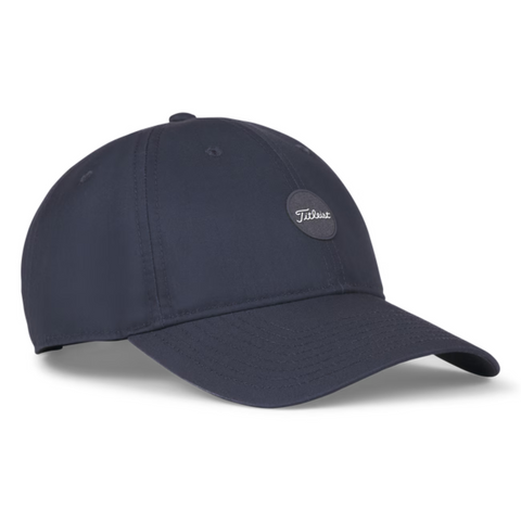 The Titleist 2025 Montauk Lightweight Cap in navy features a curved brim and a small circular patch with the Titleist logo, offering style and comfort for golf or casual wear.