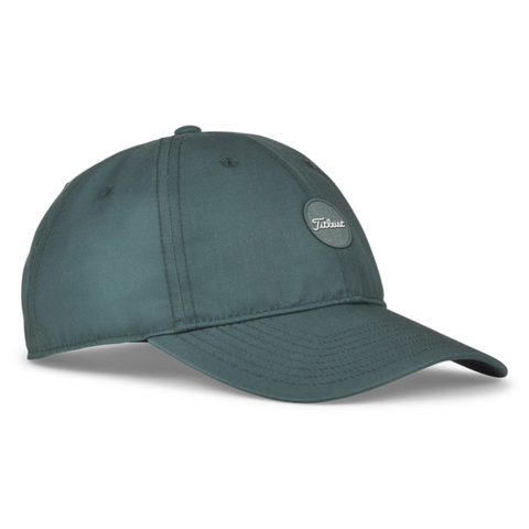 The Titleist 2025 Montauk Lightweight Cap is a dark green hat with visible stitching, a curved brim, and an oval Titleist logo patch—ideal as a lightweight golf hat for any golf cap NZ collection.
