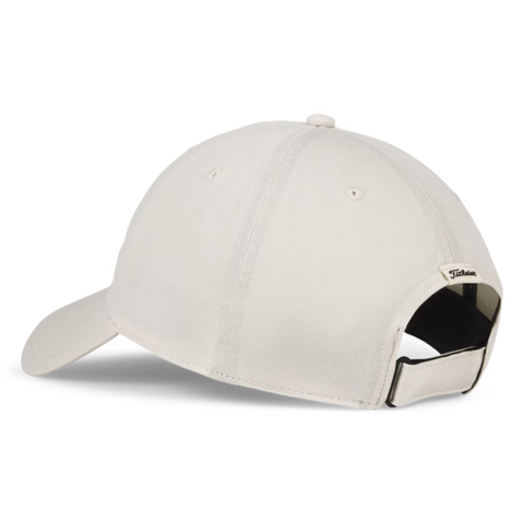 The Titleist 2025 Montauk Lightweight Cap in light beige is displayed from the back, featuring an adjustable black strap and a small rectangular Titleist logo tag—making it a perfect lightweight golf hat for any golfer.