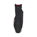 The Titleist 2025 Players 4 Carbon Stand Bag in black and red stands upright on a white background, showcasing ultra-lightweight construction, carbon fiber legs, multiple zippered pockets, and the Titleist logo.