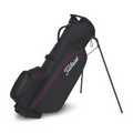 The Titleist 2025 Players 4 Carbon Stand Bag in Black/Black/Red features ultra-light carbon fiber legs, multiple zippered compartments, an extended stand for support, and a top carrying handle.