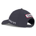 The Titleist 2025 Tour Performance Cap in dark gray is shown from the back and side, featuring a white PRO V1 logo on the side and a red-edged Titleist patch above its adjustable black strap—an essential golf hat for performance.
