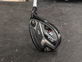 Used Titleist 818 H1 27 degree right-handed hybrid on Golf 360 dark charcoal workshop bench