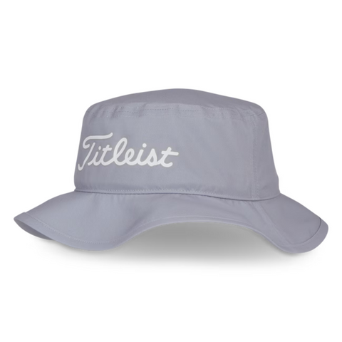 The Titleist Breezer Bucket Hat is a light gray, wide-brim hat offering sun protection, with Titleist embroidered in white script on the front—perfect for long days on the golf course.