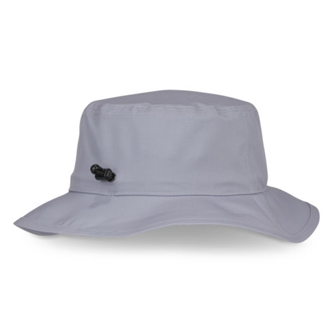 The Titleist Breezer Bucket Hat by Titleist features a light gray wide brim and a black side adjustable toggle, offering sun protection. Shown against a white background.