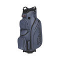 A blue Titleist Cart 14 StaDry Golf Bag with black accents and multiple zippered compartments stands upright, displaying the waterproof design and prominent Titleist logo on the side.
