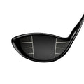 Golf club face with a black finish on a white background