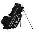The Titleist Hybrid 14 Golf Bag, in black with white accents and the Titleist logo, stands upright on its legs. It features a 14-way top divider for club organization, showcased against a white background.