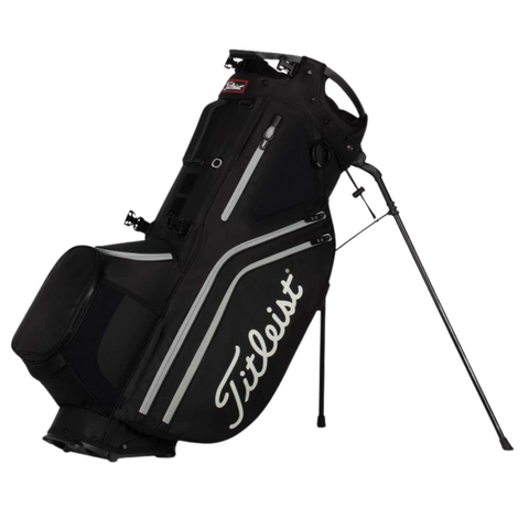 The Titleist Hybrid 14 Golf Bag, in black with white accents and the Titleist logo, stands upright on its legs. It features a 14-way top divider for club organization, showcased against a white background.