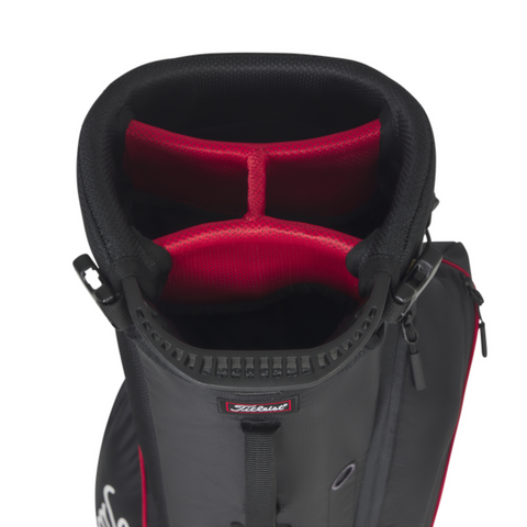 A top-down view of the Titleist Players 4 Carbon Stand Bag 2025 in black, featuring red-lined four-club dividers, carbon fiber legs, and the Titleist logo on the front.