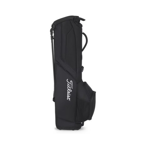 A black Titleist Players 4 Carbon Stand Bag 2025 stands upright on a white background, featuring carbon fiber legs, a spacious side pocket, and Titleist in white script along the side.