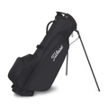 The Titleist Players 4 Carbon Stand Bag 2025 is an ultra-lightweight black golf bag with carbon fiber legs, side pockets, a carrying handle, and the white Titleist logo on the side for easy transport.