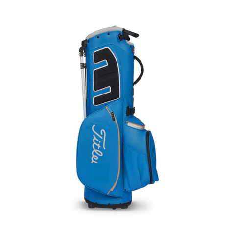A blue Titleist Players 5 Stadry Stand Bag by Titleist, a lightweight waterproof golf bag with several zippered compartments and a black handle, is shown standing upright against a white background.