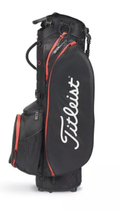 The Titleist Players 5 StaDry Stand Bag is a lightweight, waterproof black golf bag with red accents, zippered pockets, and the white Titleist logo on the side. It stands upright against a white background.
