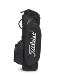 The black Titleist Players 5 StaDry Stand Bag stands upright with the white Titleist logo on its side, multiple pockets, and a lightweight, waterproof design for all-weather play.