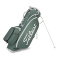 The Titleist Players 5 Stand Bag features a green design with white accents, the classic Titleist logo, multiple pockets, a durable stand, and a convenient carry handle for easy use on the course.