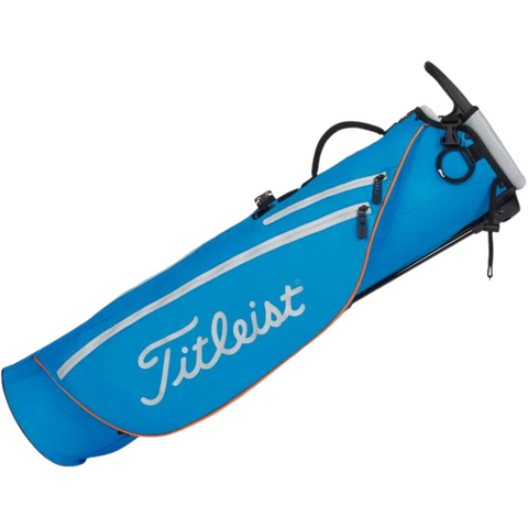 The Titleist Premium Carry Bag is a blue lightweight golf bag with white zippers and accents, a stand, handle, shoulder strap, and the Titleist logo on the side for easy carrying.