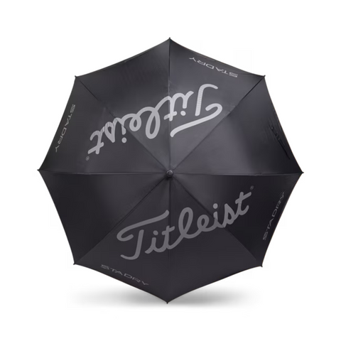 The Titleist StaDry Single Canopy Umbrella in black features bold white Titleist script and StaDry branding on several panels, providing reliable waterproof rain protection.