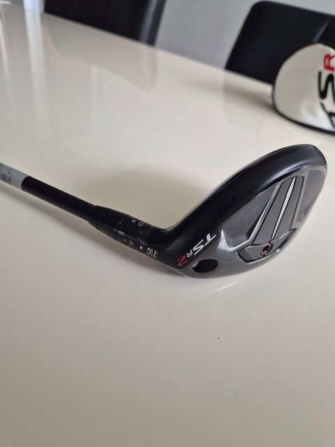 Angled sole and hosel view of used Titleist TSR2 4 hybrid with headcover
