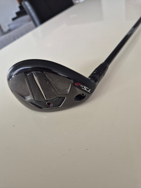 Angled sole view of Titleist TSR2 4 hybrid showing cosmetic wear
