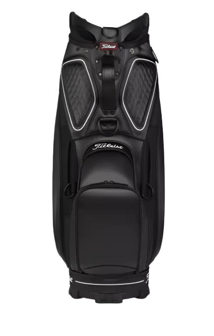 The Titleist Tour Golf Bag in Black/White by Titleist features multiple zippered compartments and padded sections, standing upright on a white background.