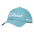 The Titleist Tour Performance Cap is a light blue golf cap made from lightweight fabric, featuring Titleist embroidered in white on the front and Pro V1 stitched in white on the left side.