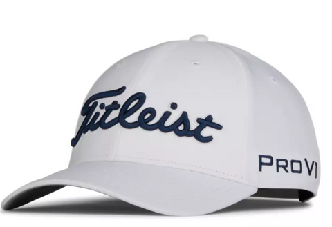 The Titleist Tour Performance Cap in White/Navy features navy Titleist embroidery on the front, Pro V1 stitching on the side, a curved brim, and ventilation eyelets for comfort.