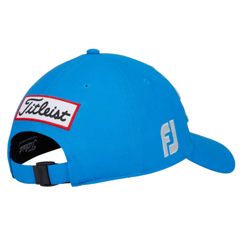 The Titleist Tour Performance Cap is a bright blue golf hat with a curved brim, white FJ side logo, and a rectangular Titleist patch above the adjustable strap—designed for comfort and breathability on the course.
