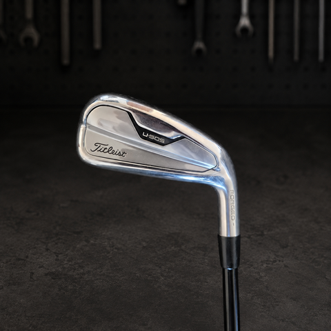 Used Titleist U505 3 iron on the Golf 360 dark workshop bench