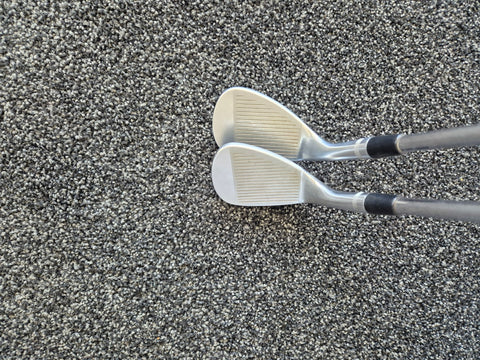 Angled face view of the used Titleist Vokey SM7 54 and 58 degree wedges