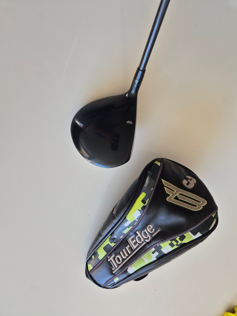 Crown and scuffed matching headcover of used right-handed Tour Edge Bazooka 3 wood