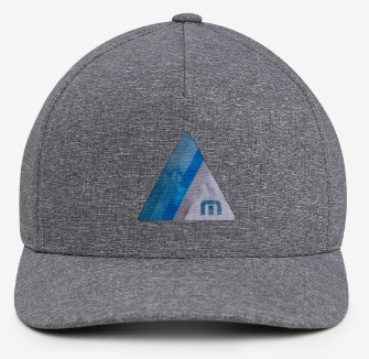 The Travis Mathew The Heather Cap is a gray golf hat featuring a blue and white geometric logo with an “m” on the front, offering stylish design and moisture-wicking comfort for active days.