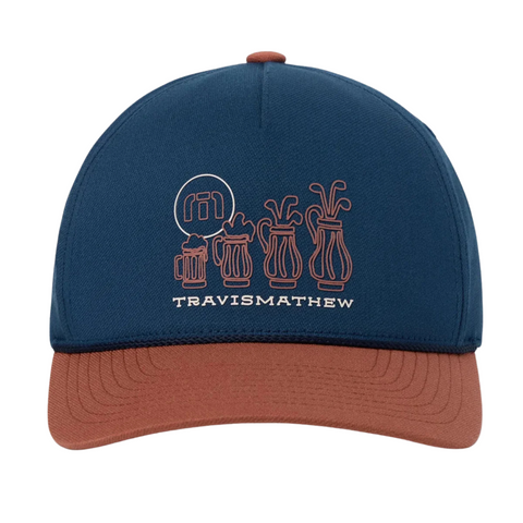 The Travis Mathew Beerly Beloved Snapback Hat in Titan Blue features a brown brim, white line art of four golf bags, and TRAVISMATHEW embroidery on the front.