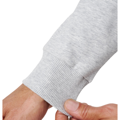 A close-up of a hand pinching the ribbed cuff of the TravisMathew Cloud 1/4 Zip 2.0 Men’s Pullover in Heather Light Grey by Travis Mathew.