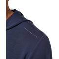 Close-up of a person wearing the Travis Mathew Cloud 1/4 Zip 2.0 Men’s Pullover in Heather Blue, featuring subtle white TRAVIS MATHEW branding on the shoulder, set against a plain white background.