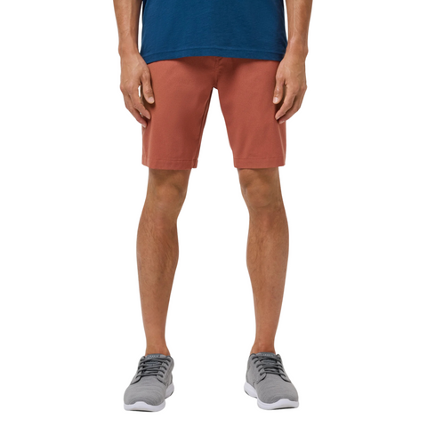 A person wearing a blue t-shirt, Travis Mathew Mens Step Dance 9 Shorts in Maple, and gray sneakers stands facing forward, shown from shoulders to feet against a plain white background.