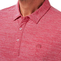 A close-up of a person wearing the TravisMathew Mens The Heater Polo in Heather Scooter, a red heathered lightweight golf shirt with a collar, buttons, and Travis Mathews small embroidered logo on the left chest. Photo shows shoulders to upper chest.