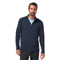 A man with short dark hair and a beard wears the TravisMathew The Heater Quarter Zip Mens Long Sleeve Polo by Travis Mathew over a light blue collared shirt, standing against a white background and smiling softly.