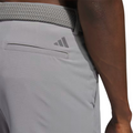 Close-up of the back of the grey Adidas Ultimate365 8.5-Inch Men's Golf Shorts, showing a back pocket with the Adidas logo above it and a woven grey belt.