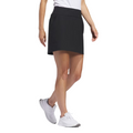 Side view of the black Adidas Ultimate365 Solid Women's Skort on model, shown with white athletic shoes. The skort has a fitted waistband and falls above the knee.