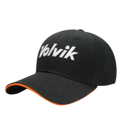 The Volvik Cap | Black/White features white embroidered front letters, orange brim trim, and a lightweight adjustable fit for comfort all day on or off the golf course.