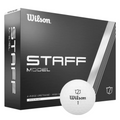 A box of Wilson 2024 Staff Model Golf Balls by Wilson, designed for tour performance, with a white ball in front displaying the Wilson logo and number 1. The black box has bold white text and sleek silver accents.
