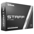 A black box of Wilson 2024 Staff Model Golf Balls features white text and silver stripes, showcasing 4-piece urethane construction for high-spin tour performance, with white/blanc on the front. Brand: Wilson.